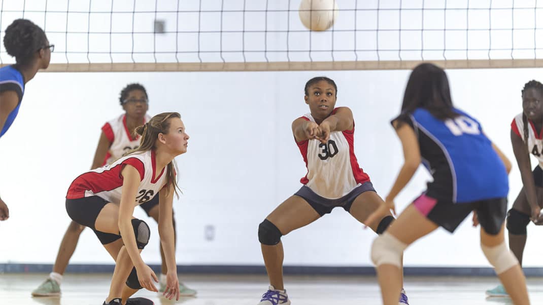 Teenage girls playing volleyball to increase physical activity levels