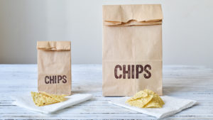 Small and large bag of chips to represent overeating