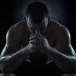 Dark image of man with head down to show use of exercise for depression