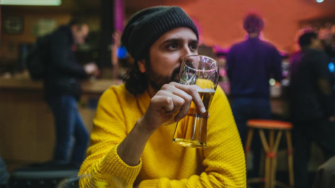 Man holding beer to show link between alcohol and brain function
