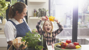 Mother with daughter in a kitchen to show food and risk of celiac disease in children