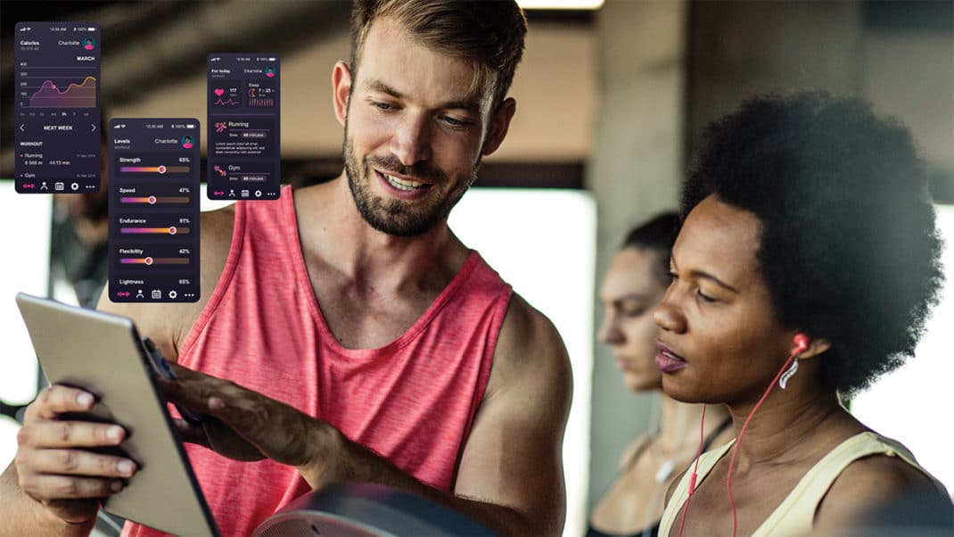 Personal trainer using fit tech data with client