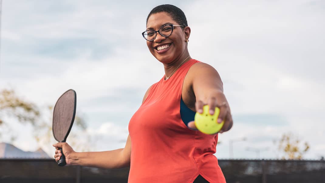 Woman playing tennis to stay active and prevent type 2 diabetes