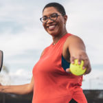 Woman playing tennis to stay active and prevent type 2 diabetes