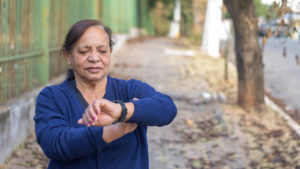 Woman looking at her wearable activity tracker