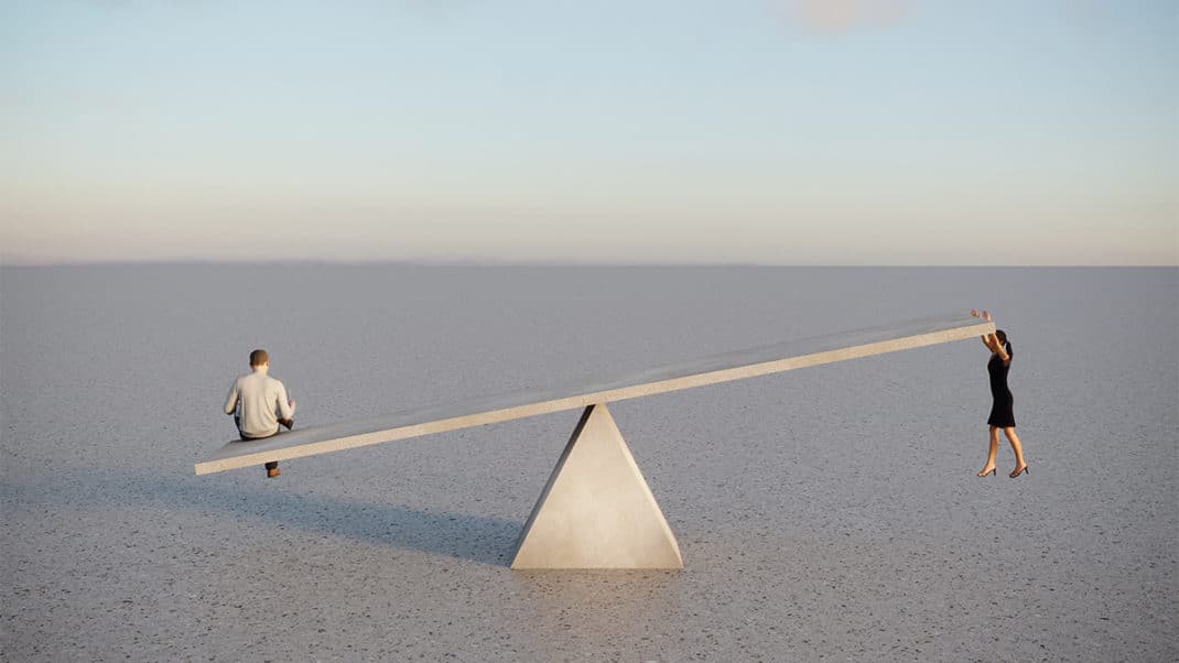 Man and woman on seesaw to show inequity and gender gap