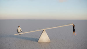 Man and woman on seesaw to show inequity and gender gap