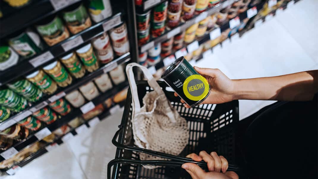 Person holding labeled can of food to show FDA rules on nutrition labels