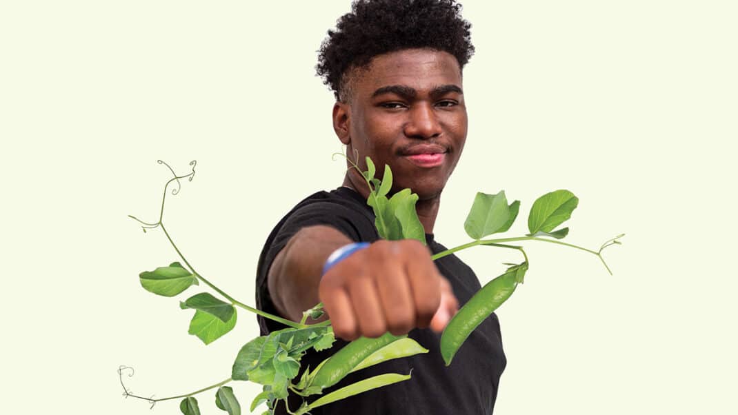 Man holding plant to illustrate strength from plant protein