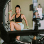 Fitness influencer working out in front of camera and in need of fitness certification