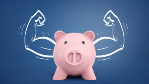 Piggy bank with flexing arms behind it to represent compensation trends in fitness