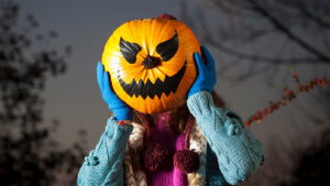 Person holding up jack o'lantern to question whether plant-based is healthier