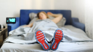 Person sleeping with athletic shoes on to show sleep benefits for health goals