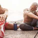 Fit woman and man next to a protein shake