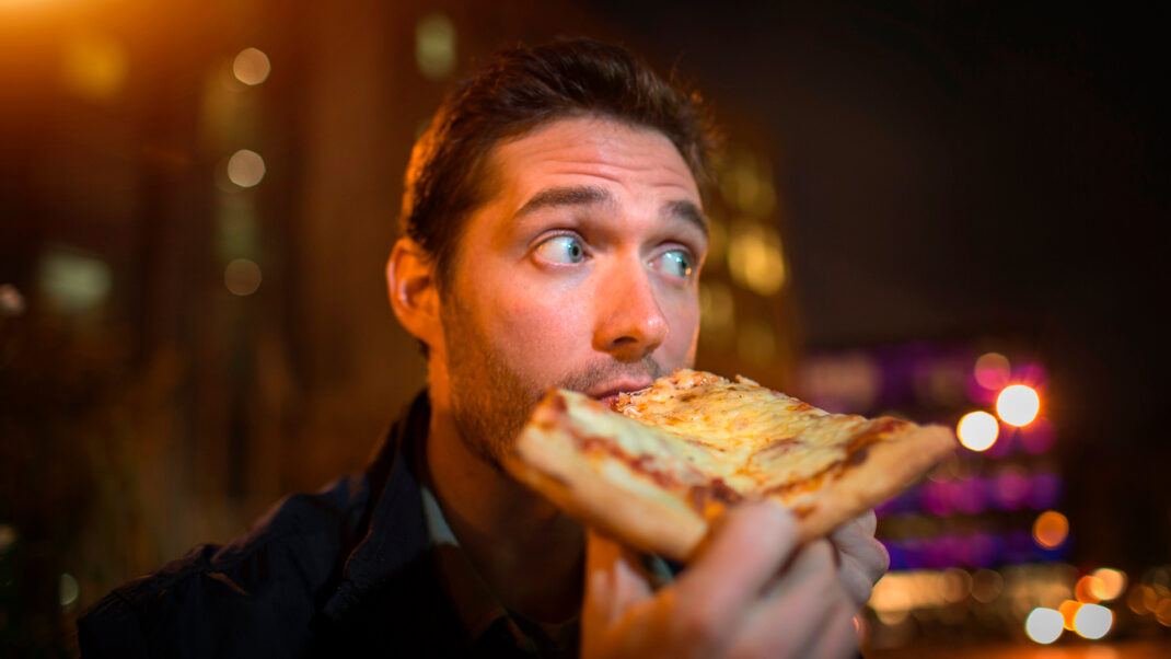 Man eating comfort food for stress