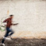 Blurry person on sidewalk